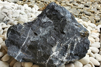 Black stone boulder
